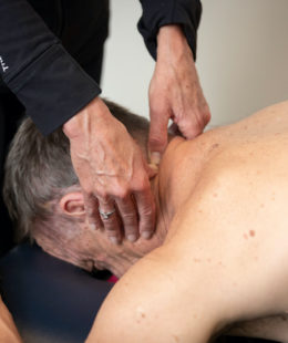 Man receiving neck physiotherapy treatment for neck pain