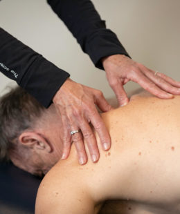 Man receiving upper back physio massage