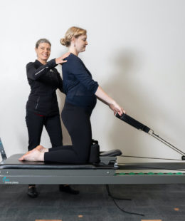 lady using clinical pilates reformer